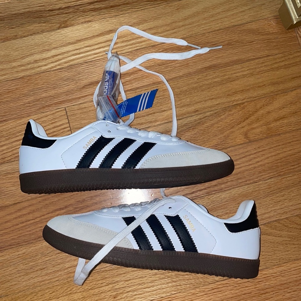 white and black adidas sambas.
